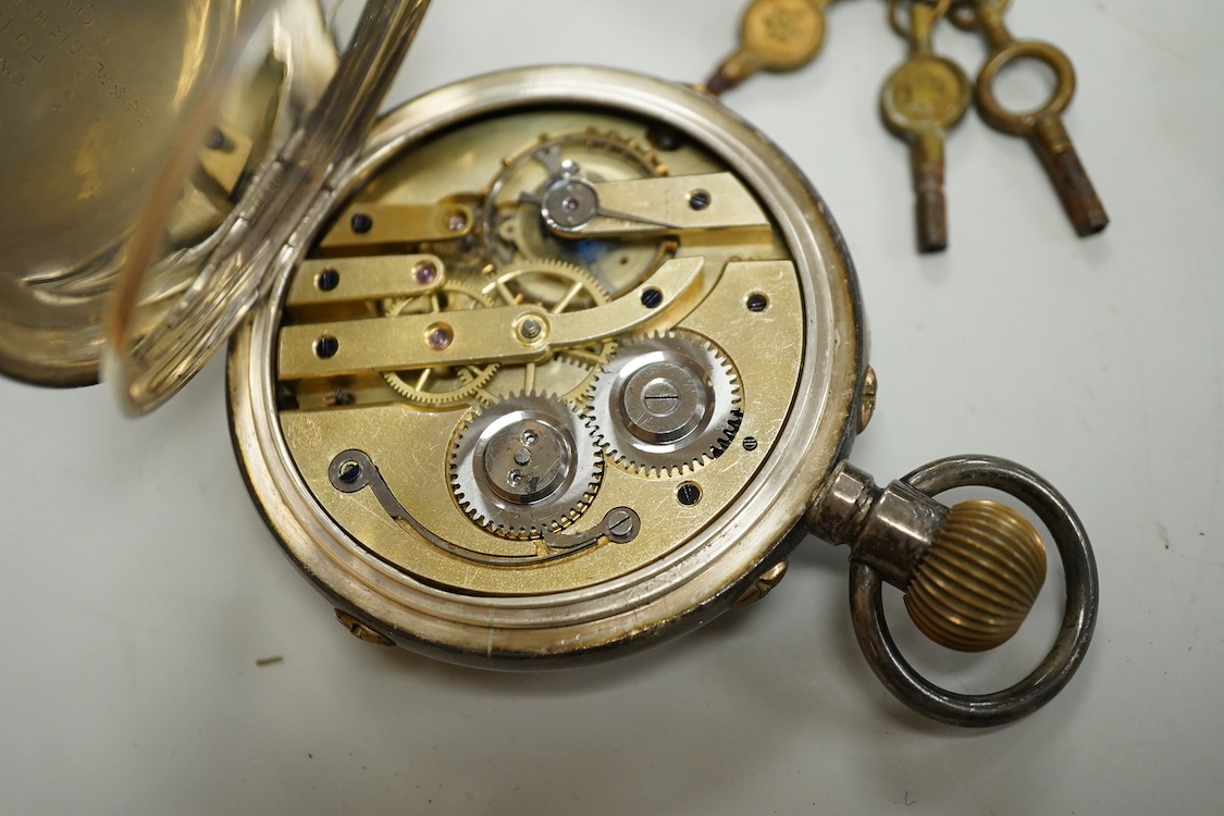 A George V silver cased goliath calendar moon phase open faced pocket watch, case diameter approx. 67mm(a.f.), together with five other pocket watches, including silver and white metal Waltham, a Camerer Cuss chrome case